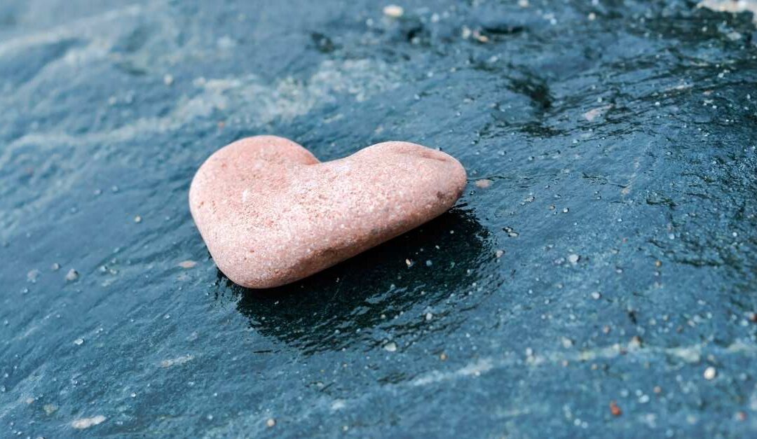 Pink stone heart on blue background, representing Self-Confidence, Courage, Encouragement, Resilience, Heart
